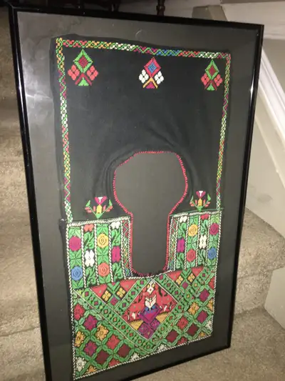 Framed embroidered child’s vest possibly native black background with black metal frame 14”wide by 2...