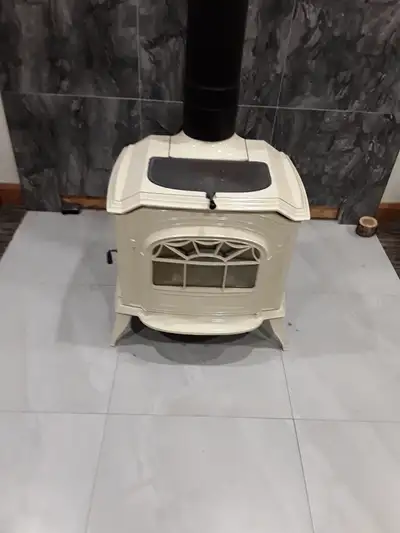 Vertmont cating wood stove . Needs new back fire wall , new bottom grills , one year old fire bricks...
