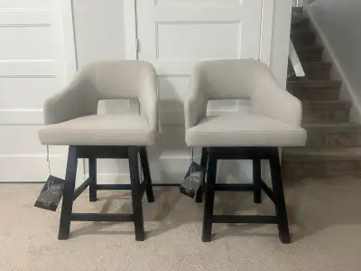 Selling a pair of brand new, fully assembled Signature Design by Ashley Tallenger 25” Swivel Bar Sto...