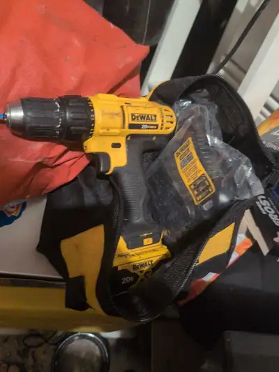 This DeWalt 20V MAX cordless drill/driver kit includes a drill, battery, charger, and carrying bag,...