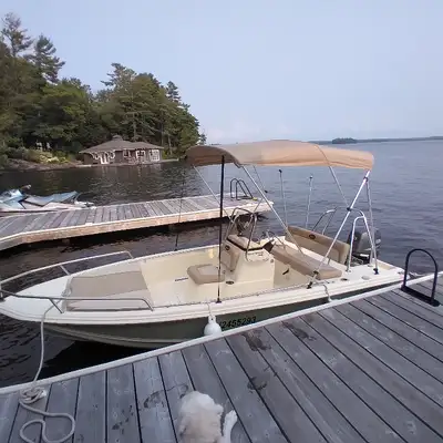 2010, 16ft. Scout Sportfish 160 boat and trailer. Off white fiberglass exterior with soft green acce...