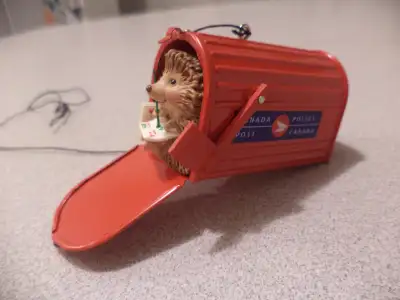 Hall mark tree ornament CanadaPost hedgehog. no moving parts except the flag. 2-3" . No tax. Transco...
