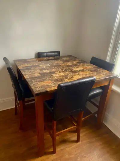 Dining table and 4 leather chairs set great condition , View more