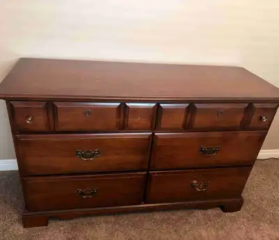 Antique dresser with mirror. Mirror actually attaches vertically but we hung it on the wall for a di...