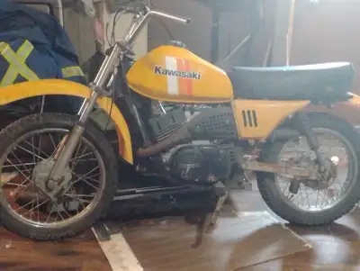This original 1981 Kawasaki KT 100 features a classic yellow design and remains in used condition, p...