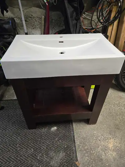 30" bathroom vanity with sink In good shape Minor water damage on bottom of legs