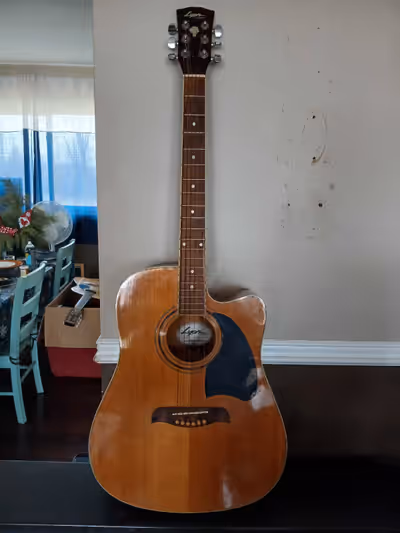 This acoustic/electric guitar is made by Lyon, in affiliation with Washburn guitars. It features a b...