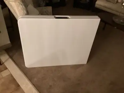 A white fold up table used one day for a wedding 6 feet long very light and very easy to close for s...