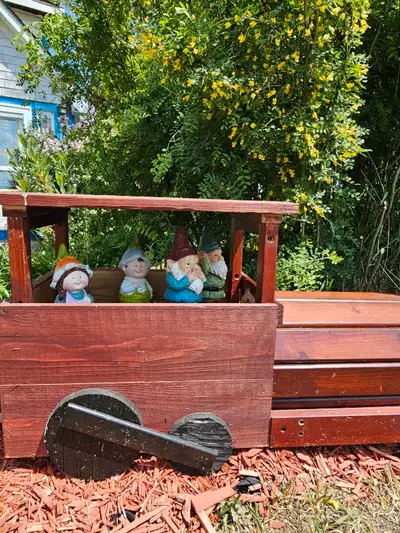 Handcrafted train planter boxes, expertly built from durable treated or cedar lumber for long-lastin...