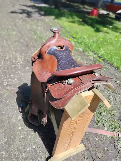 Affordable western saddle features a two toned deep seat and silver accents ideal for barrel racing...
