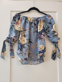 Bundle of two women's size small floral tops, blue and black top