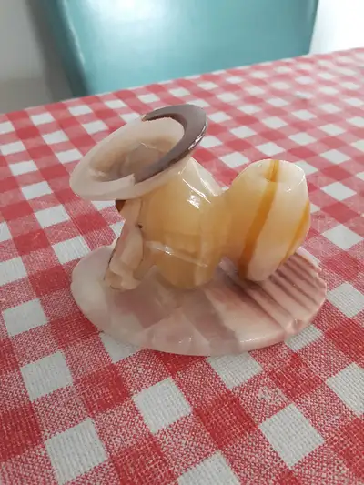 Mexican is leaning against a barrel and on an alabaster base. Measurements are 3 3/4" L, 2 1/2" H &...
