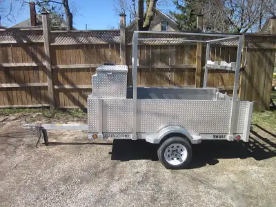 This U4x84-W trailer has been converted into a lightweight aluminum canoe/kayak trailer with two sto...