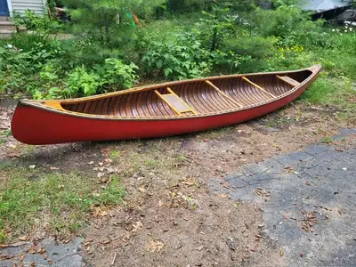 This is a classic cedar strip and canvas 15 foot canoe with all original wood. One cane seat needs r...