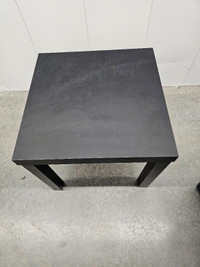 Two matching black wood coffee tables