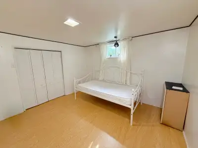 Fully furnished large private room with walk-in closet available for female in a shared basement nea...