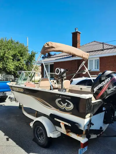EZ load trailer 2 live wells and 1 bait well 55 elertic motor Built in battery charge 2 electric dow...