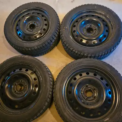 selling four 17 inch Bridgestone winter tires with steel rims for $600. two tires are 11/32 of tread...