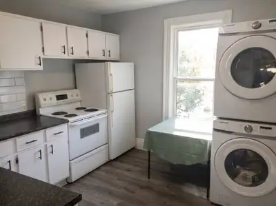 This spacious two-bedroom apartment features high ceilings and natural light streaming in from an en...