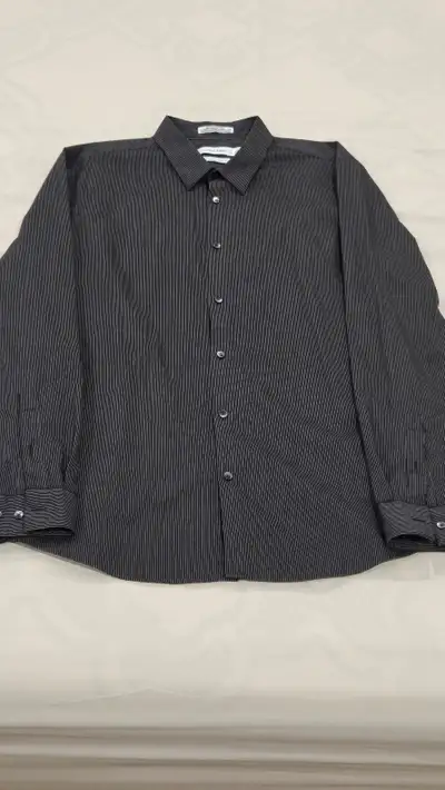 Calvin Klein men's long sleeve dress shirt in size large. Has a couple of light stains near the bott...