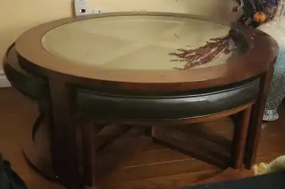 Glass topped circular coffee table with stools, View more