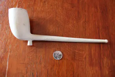 Hi. I have an antique clay pipe for sale. The pipe shows some wear and marks. On side is marked "McD...