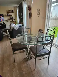 Kitchen table and four chairs, also small chip on table top.