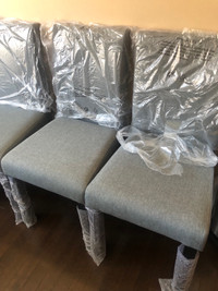 A set of 4 dining chairs gray  ( brand new in the box)