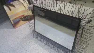 Wall mirror with beveled glass and metal frame, View more