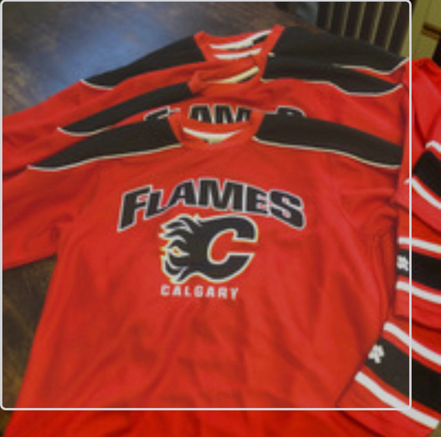 Four youth Calgary flames jerseys in Hockey in St. Albert