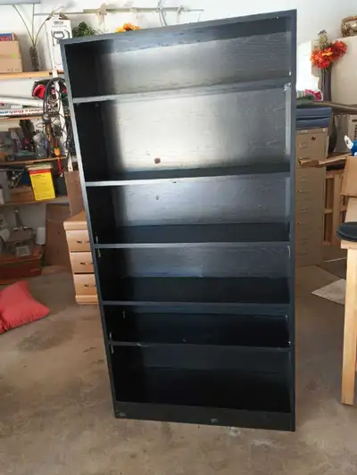 This is a black bookcase with multiple shelves, perfect for organizing your books or displaying your...
