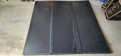 Tonneau cover for trucks with a 77 inch long by 69 inch wide bed.