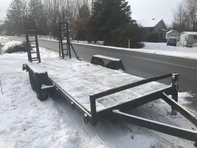 This is a sturdy flatbed trailer, ready to haul your equipment or materials, with wood flooring and...