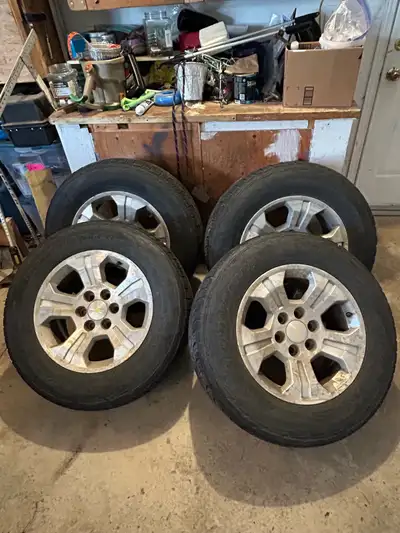 Set of 4 rims and tires from 2014 Chevy Silverado. The rubber on two of the rims is good (see photos...
