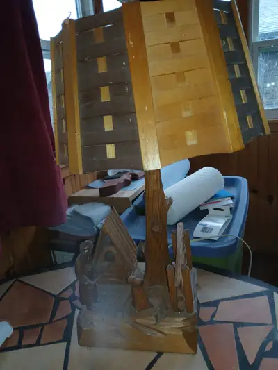 Old carved wooden lamp of a Baker baking bread, View more
