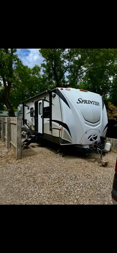 Well maintained couples camper with a large rear bathroom, large slide with dinette and sofabed, upg...