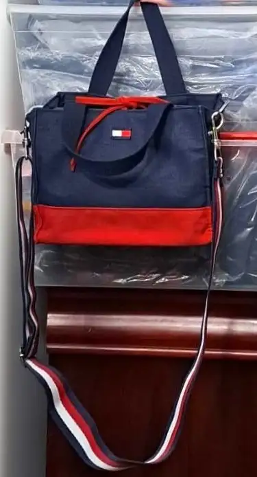 This Tommy Hilfiger mini tote features the iconic navy and red colorblock design. While this model w...