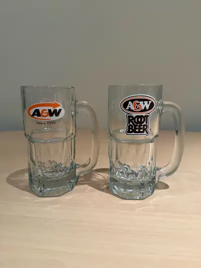 These are two A&W Root Beer mugs, perfect for collectors or anyone who enjoys a frosty mug of root b...