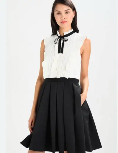 This Ted Baker dress is a cream colour with black detail around the neck. It is in excellent conditi...