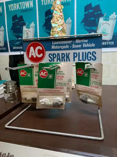 These 4 vintage packs of AC spark plugs and vintage AC spark plugs display stand are $250. The displ...