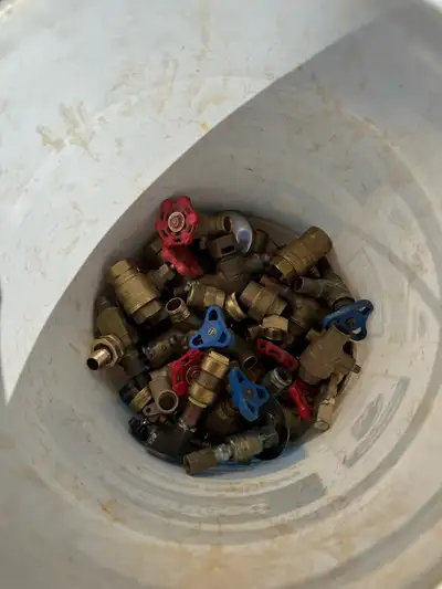 5 gallon pale half full of brass fittings, full 5 gallon pale of copper, urinal fittings, bag of PVC...
