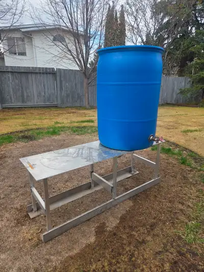 45 gallon drum water barrel for sell and a metal aluminum stand--18''w x55''l x21''h. All in great c...