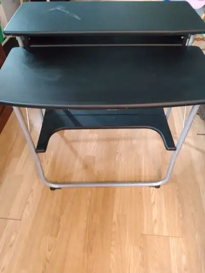 Black foldable desk. Has crazy glue stain across the top and some rust on the legs. Still sturdy, fo...