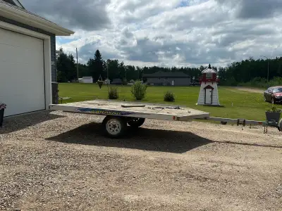 Aluminum two place snowmobile trailer with pull out ramp. Made October 2005 by Karavsn trailer. Ligh...
