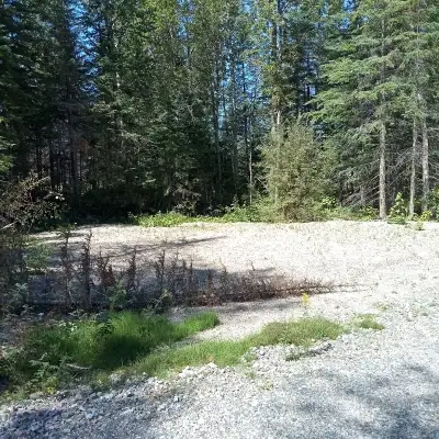 THE LOT HAS A GRAVEL PAD AND TREES , IS ABOUT A HALF ACRE IN SIZE OFF GRID CAMP SPOTS AVAILABLE- LOC...