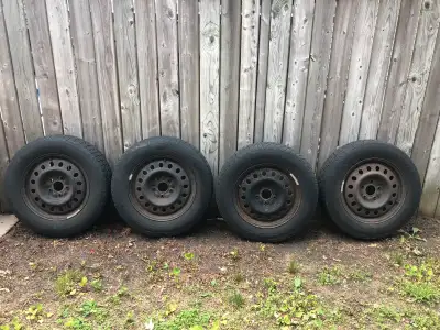 Four 255\65 R17 winter tires on rims in fair condition