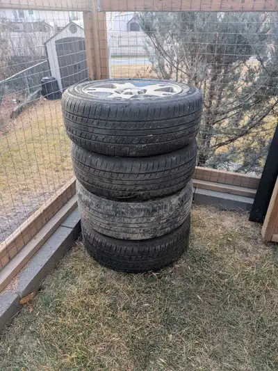Wheels and tires off a Mazda 3. Tires have only a season or 2 left on them and only 3 of the 4 rimsa...