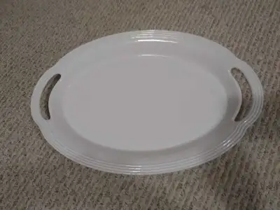 A stylish oval ceramic serving platter, no longer in production. I love this piece, but due to an up...