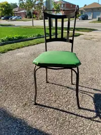 Four black cast iron patio chairs.