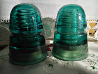 A SET OF TWO of Hemingray Blue Green Glass Insulators